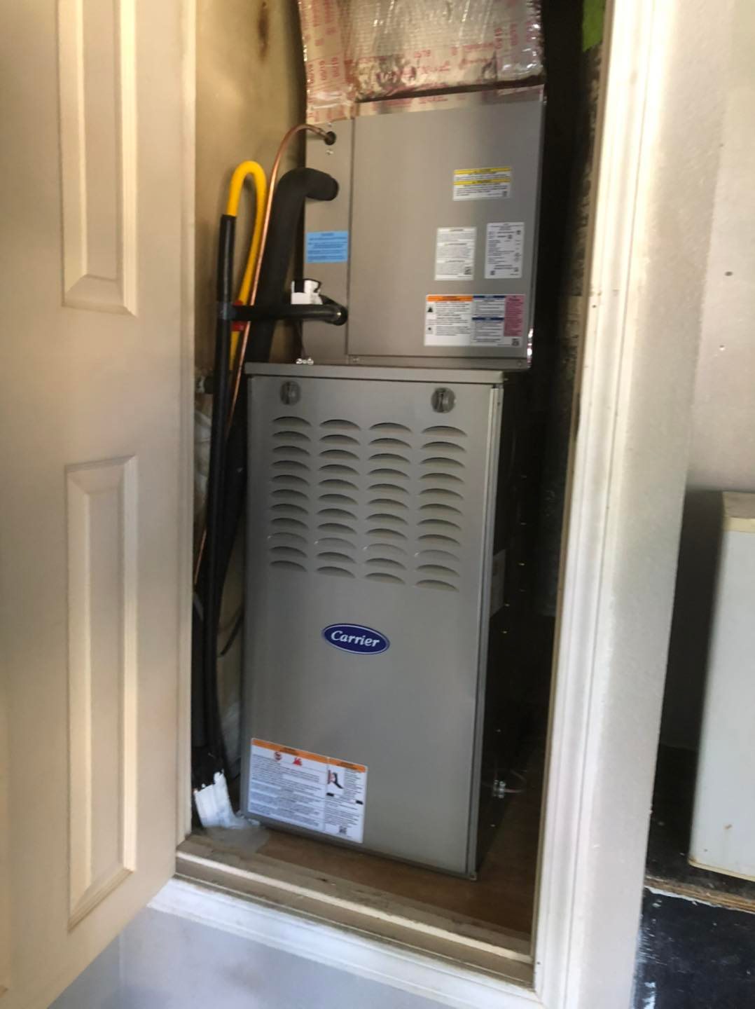 Carrier furnace and air handler in a narrow closet with refrigerant lines, insulation and open access door